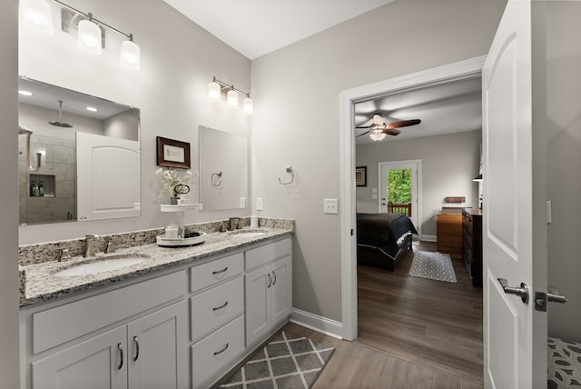457 Celie Ann Seabolt Rd, Cleveland, GA 30528 - full bath featuring a ceiling fan, wood finished floors, baseboards, tiled shower, and double vanity