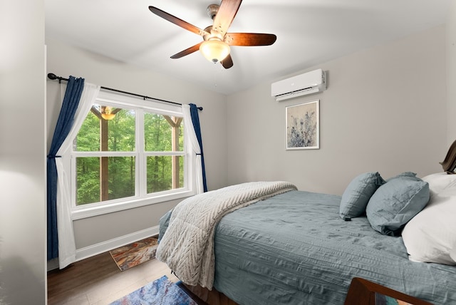 457 Celie Ann Seabolt Rd, Cleveland, GA 30528 - bedroom featuring an AC wall unit, baseboards, wood finished floors, and ceiling fan