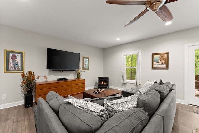 457 Celie Ann Seabolt Rd, Cleveland, GA 30528 - living room with a wood stove, ceiling fan, baseboards, recessed lighting, and wood finished floors