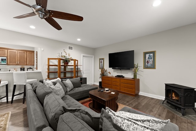 457 Celie Ann Seabolt Rd, Cleveland, GA 30528 - living area featuring a wood stove, recessed lighting, dark wood finished floors, ceiling fan, and baseboards