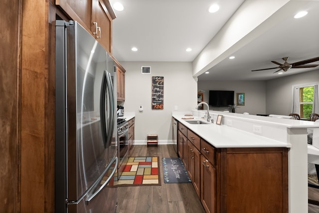 457 Celie Ann Seabolt Rd, Cleveland, GA 30528 - kitchen featuring appliances with stainless steel finishes, a peninsula, a sink, dark wood finished floors, and light countertops
