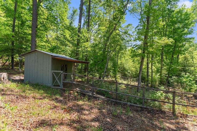 457 Celie Ann Seabolt Rd, Cleveland, GA 30528 - view of yard featuring fence, an outbuilding, a storage shed, and a forest view