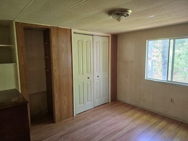 unfurnished bedroom featuring a closet and light wood finished floors