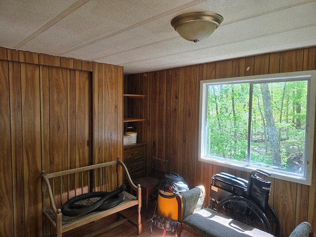 interior space featuring wooden walls and a textured ceiling