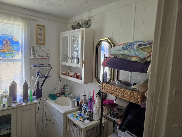 bathroom with vanity and a textured ceiling