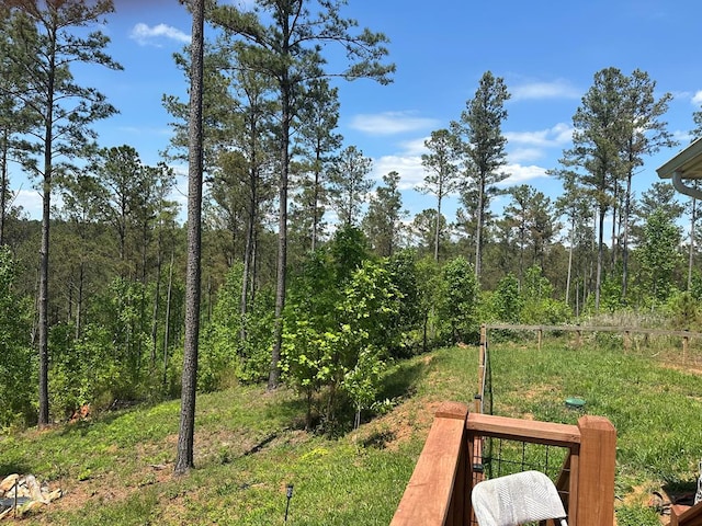 view of yard with a view of trees