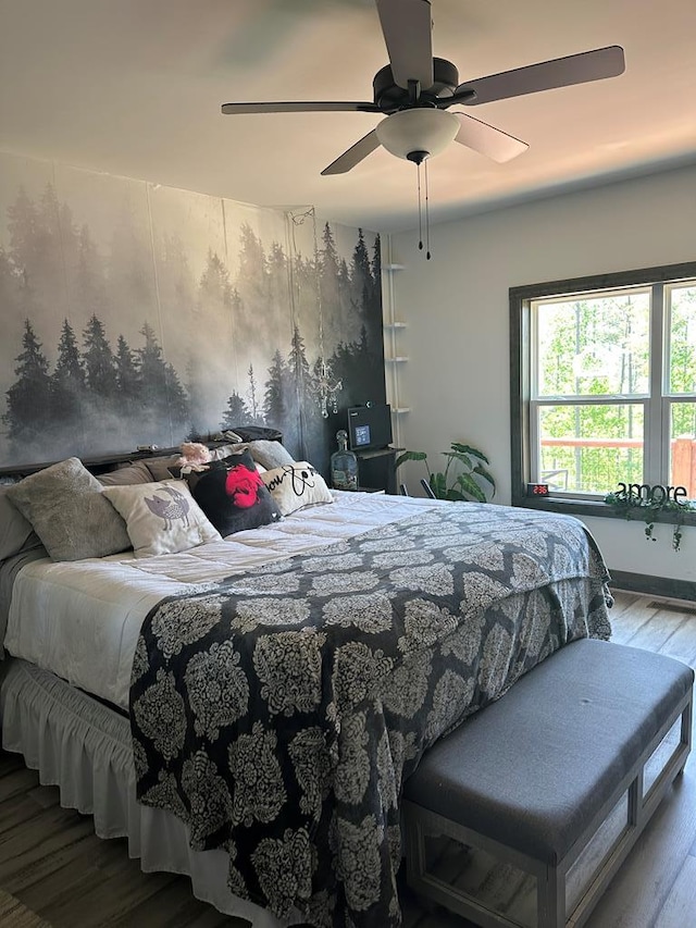 bedroom with ceiling fan and wood finished floors