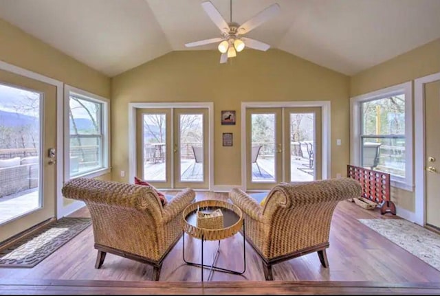 sunroom with lofted ceiling, french doors, and a ceiling fan