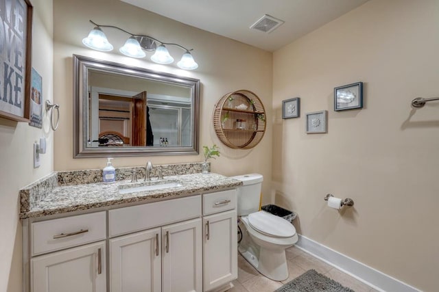 bathroom featuring visible vents, baseboards, toilet, tile patterned flooring, and vanity