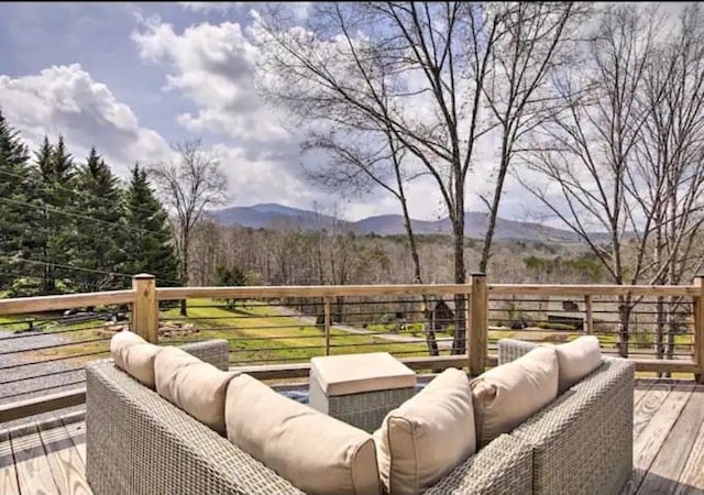 deck with a mountain view and an outdoor living space