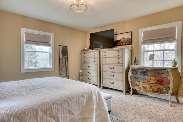 bedroom featuring carpet floors and multiple windows