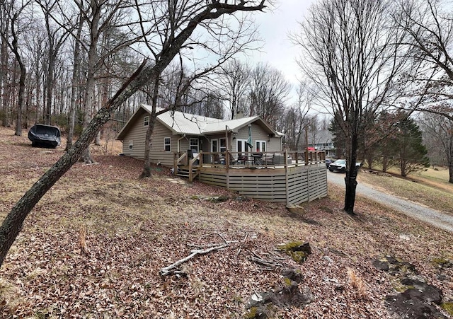 exterior space featuring driveway and a deck