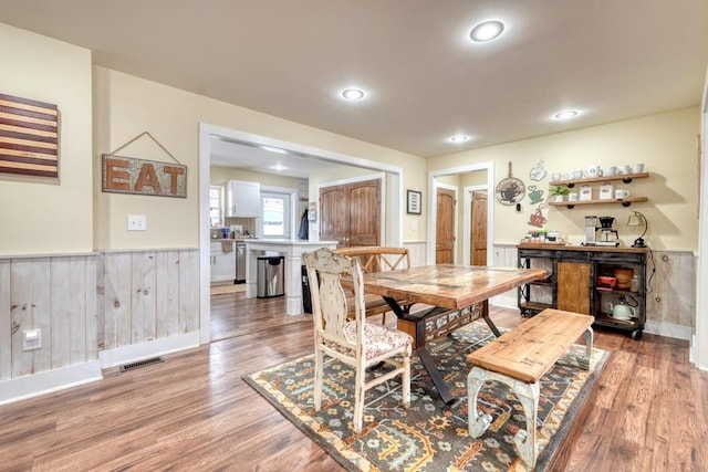 dining area with recessed lighting, wainscoting, visible vents, and wood finished floors