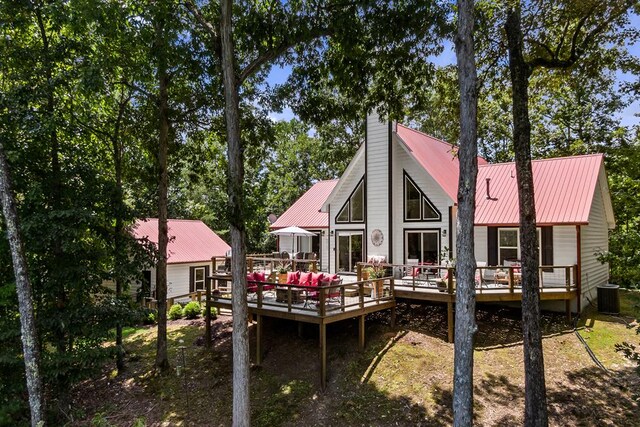 back of house featuring a wooden deck and cooling unit