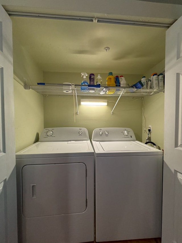 washroom with washing machine and clothes dryer