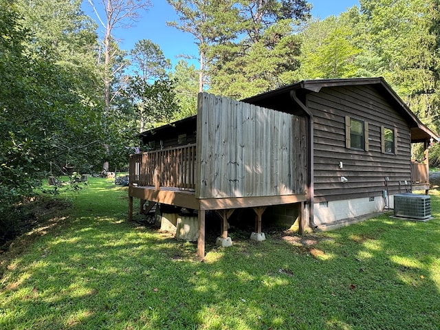 view of property exterior featuring a deck, central air condition unit, and a lawn