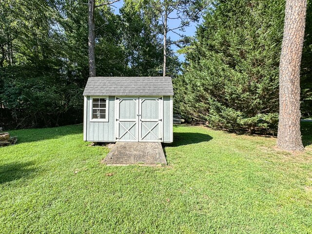 view of outdoor structure featuring a lawn