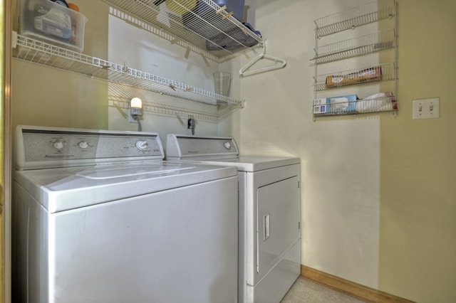 washroom featuring separate washer and dryer and baseboards