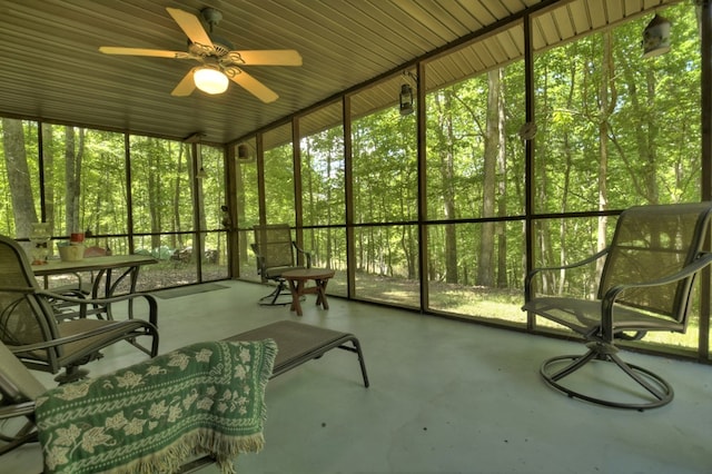 unfurnished sunroom with ceiling fan