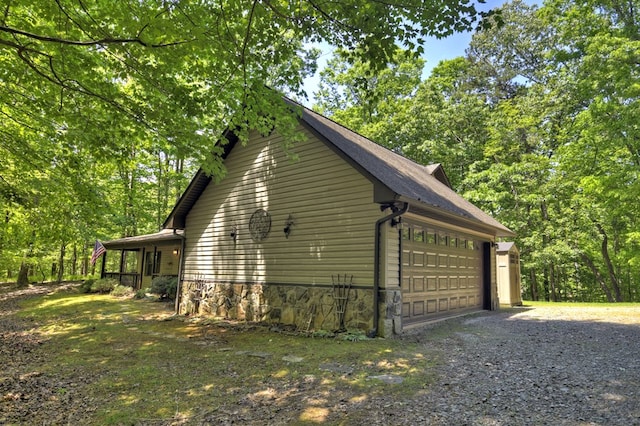 view of side of home featuring a detached garage
