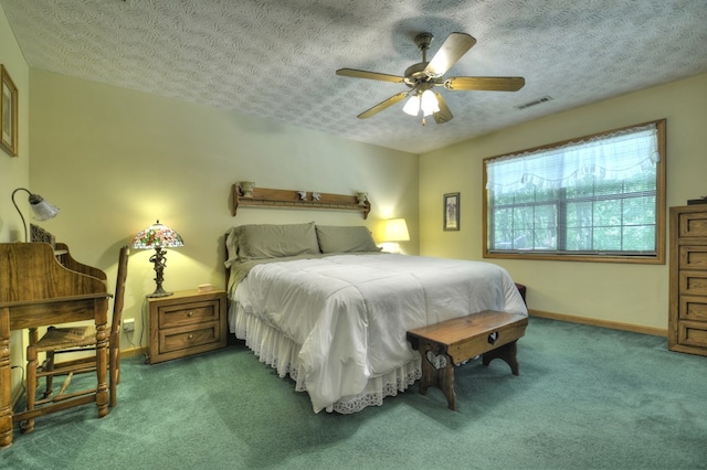 bedroom with carpet, baseboards, a textured ceiling, and a ceiling fan