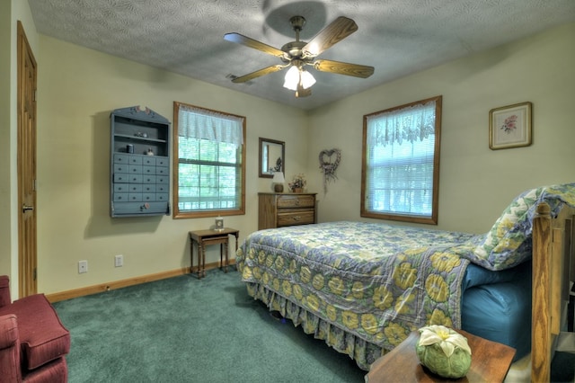 carpeted bedroom featuring baseboards, ceiling fan, and a textured ceiling