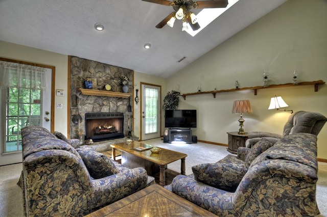 living room featuring carpet flooring, ceiling fan, baseboards, a fireplace, and lofted ceiling
