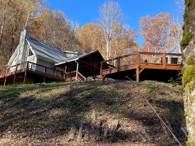 5575 Rainbow Springs Rd, Franklin, NC 28734 - rear view of house with a wooden deck, metal roof, and a chimney