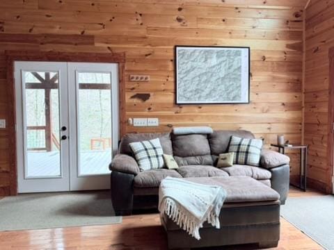 5575 Rainbow Springs Rd, Franklin, NC 28734 - living room with french doors, wooden walls, and light wood-style floors