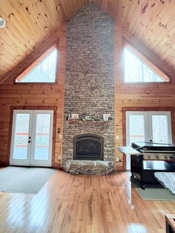 5575 Rainbow Springs Rd, Franklin, NC 28734 - living room featuring high vaulted ceiling, french doors, wooden ceiling, plenty of natural light, and wooden walls