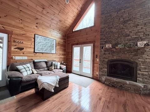 5575 Rainbow Springs Rd, Franklin, NC 28734 - living room featuring high vaulted ceiling, french doors, wood finished floors, wooden ceiling, and a stone fireplace