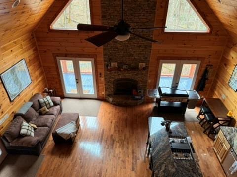 5575 Rainbow Springs Rd, Franklin, NC 28734 - living area with high vaulted ceiling, healthy amount of natural light, french doors, wooden walls, and wood finished floors