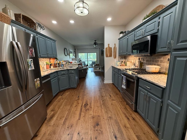209B N Berrong St, Hiawassee, GA 30546 - kitchen with stainless steel appliances, dark wood-style floors, ceiling fan, recessed lighting, and backsplash