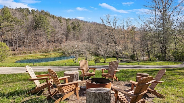 view of patio with a water view and an outdoor fire pit