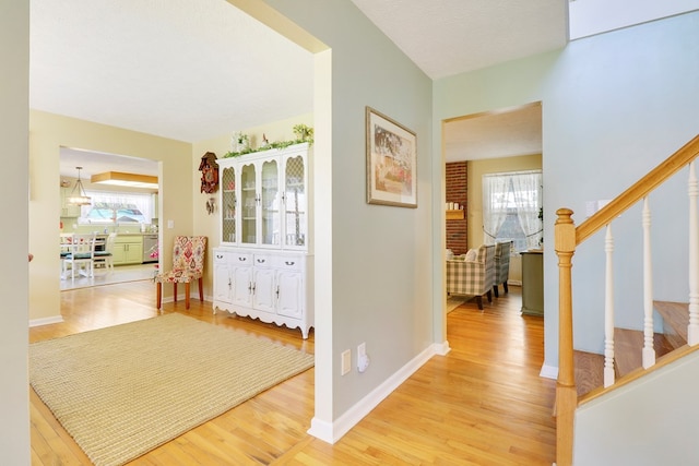 corridor featuring a textured ceiling and hardwood / wood-style floors