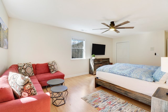 bedroom featuring a closet, ceiling fan, and light hardwood / wood-style flooring