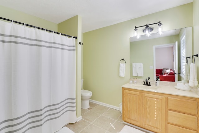 bathroom with vanity, toilet, and tile patterned flooring