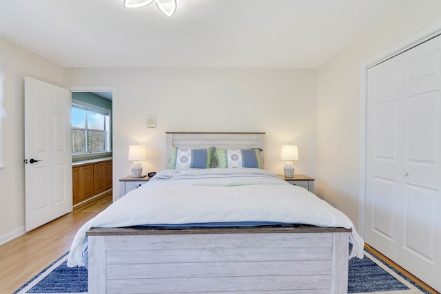 bedroom with a closet and light hardwood / wood-style floors