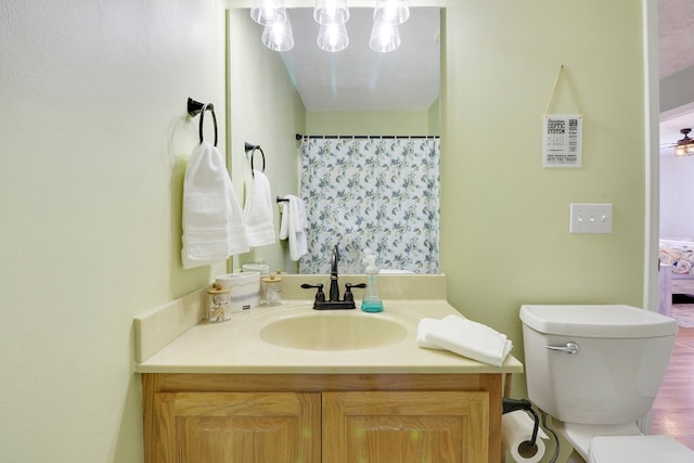 bathroom featuring vanity, hardwood / wood-style flooring, and toilet