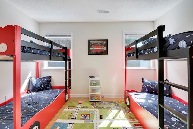 bedroom featuring light hardwood / wood-style flooring and a textured ceiling