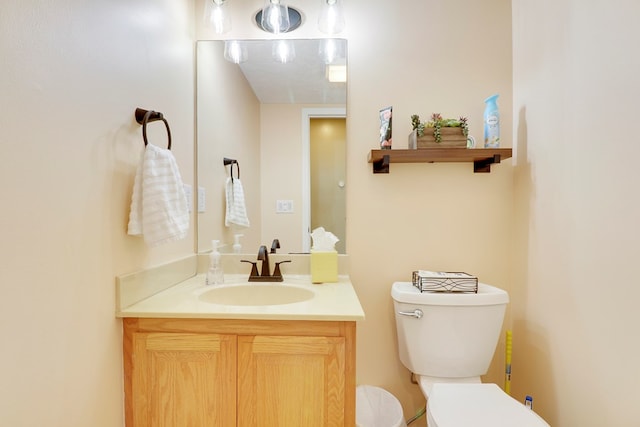 bathroom featuring vanity, a textured ceiling, and toilet