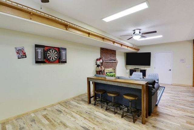 interior space with hardwood / wood-style flooring, a fireplace, and ceiling fan