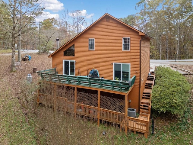 rear view of property with central air condition unit and a deck