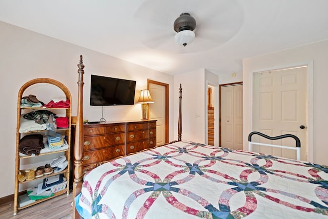 bedroom featuring a closet, hardwood / wood-style flooring, and ceiling fan