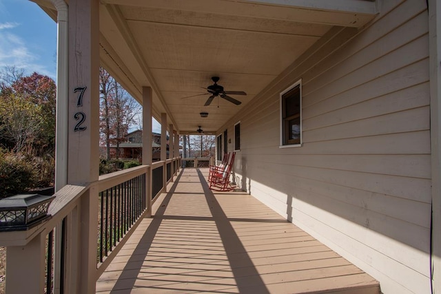 wooden deck featuring ceiling fan and a porch