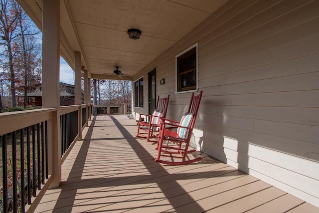 wooden terrace featuring ceiling fan and a porch