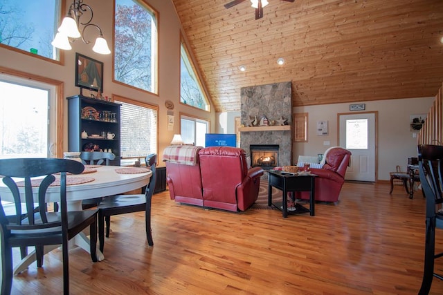 dining area with hardwood / wood-style floors, a healthy amount of sunlight, and high vaulted ceiling