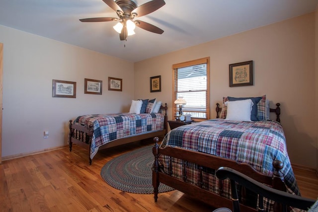 bedroom with ceiling fan and light hardwood / wood-style floors