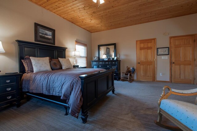 bedroom with wooden ceiling and dark carpet