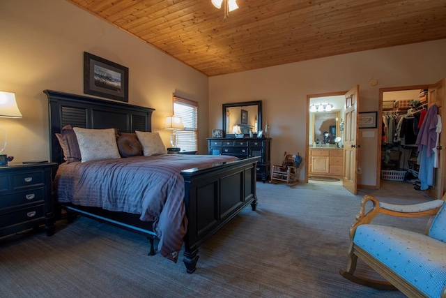 bedroom with ensuite bath, a spacious closet, wooden ceiling, dark colored carpet, and a closet